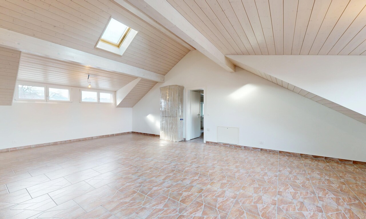 empty room with a skylight, stone finish flooring, and wood ceiling