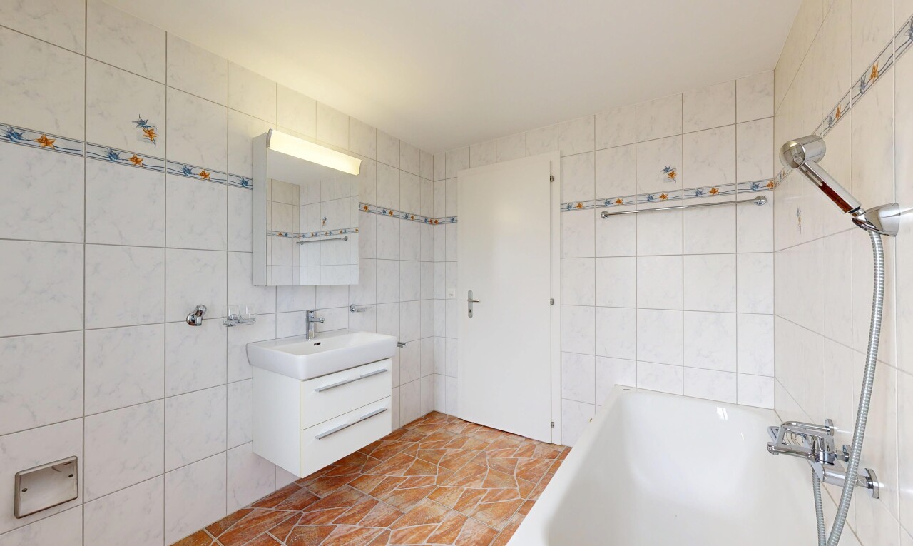 full bathroom with a garden tub, vanity, and tile walls