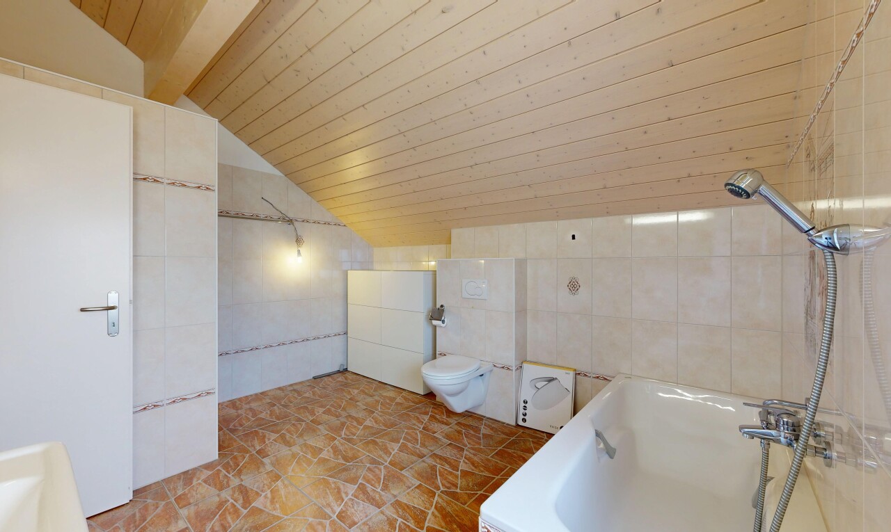 full bathroom featuring tile walls, vaulted ceiling, tiled bath, and wood ceiling