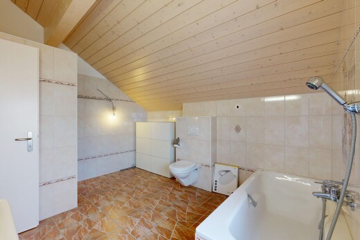 full bathroom featuring tile walls, vaulted ceiling, tiled bath, and wood ceiling