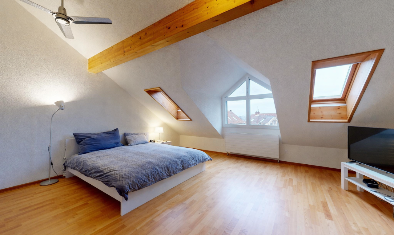 room with a skylight, a ceiling fan, light wood-style flooring, radiator, and a textured ceiling