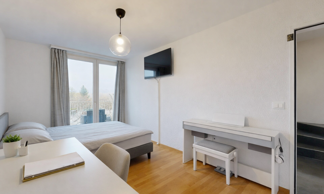 room / bedroom with light wood finished floors and access to outside