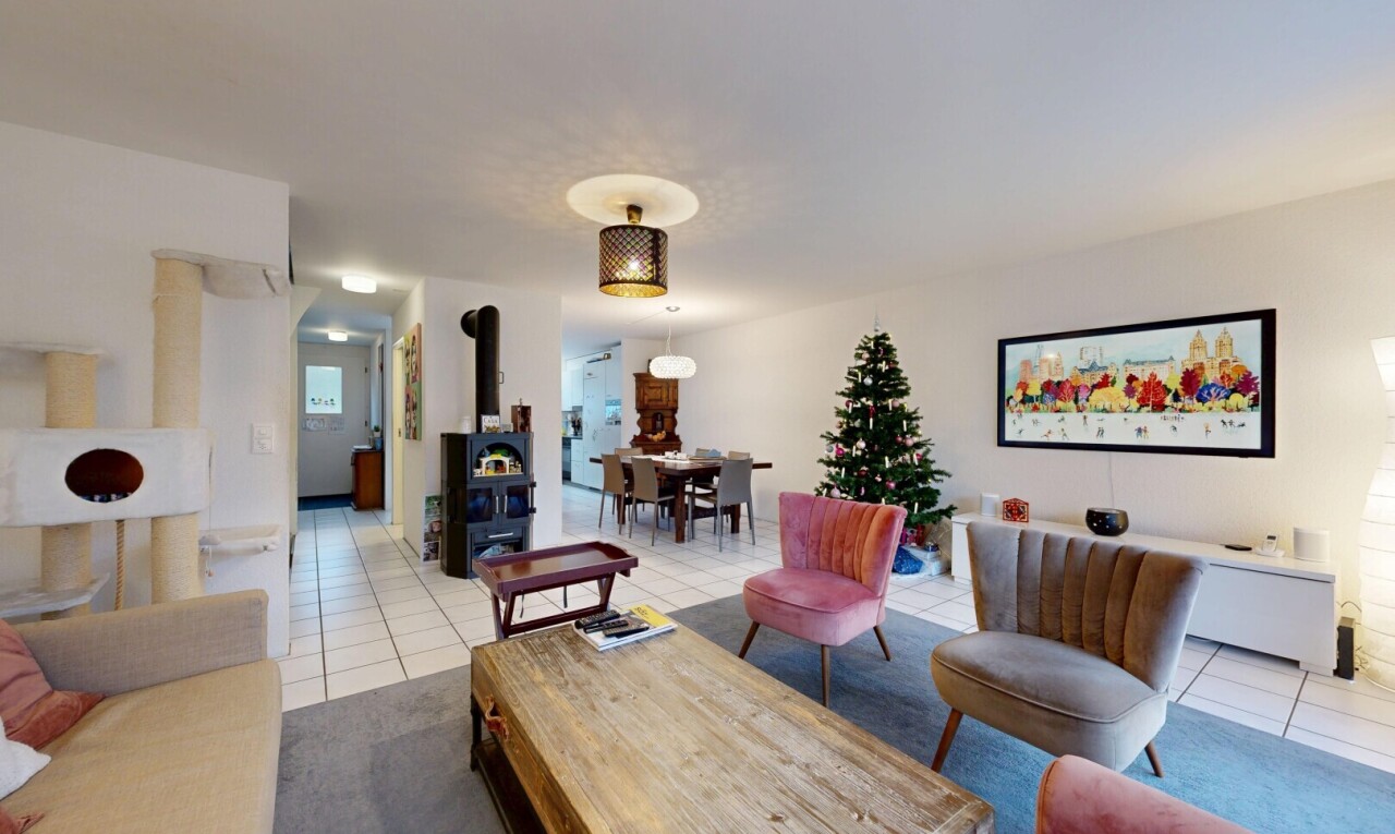 living / dining area with a wood stove and light tile patterned floors