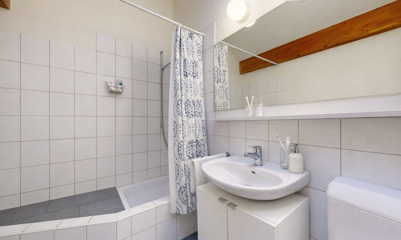 bathroom featuring vanity, tile walls, and decorative backsplash