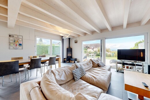 salon / salle à manger avec poêle à bois, beamed ceiling, plafond à poutres, télévision, et inside property