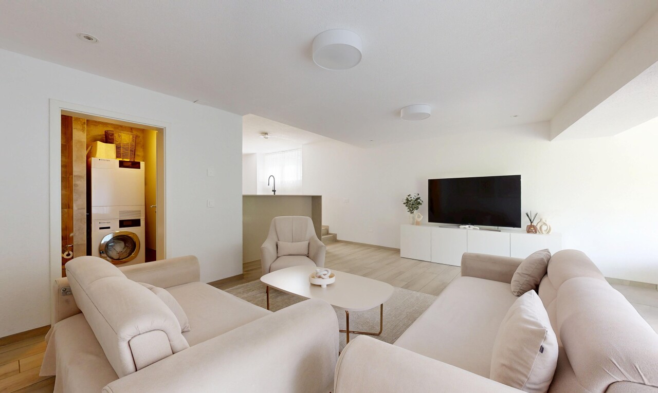 salon avec sol en finition bois, wood finish floor, cloison sèche, drywall, et télévision
