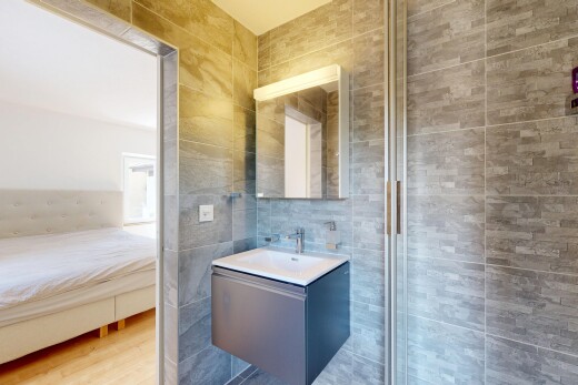 salle de bains avec miroir, tile wall, mur en carrelage, lavabo (ou coiffeuse selon le contexte), et inside property