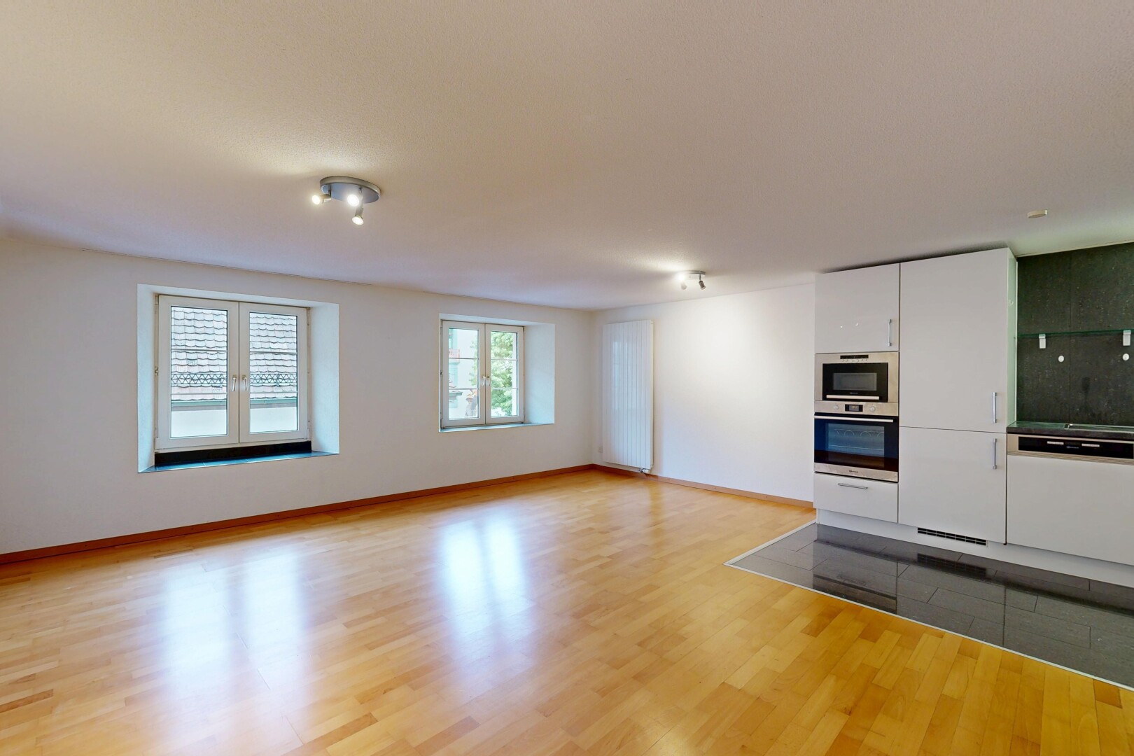pièce vide avec lumière naturelle, cloison sèche, drywall, inside property, et sol en finition bois
