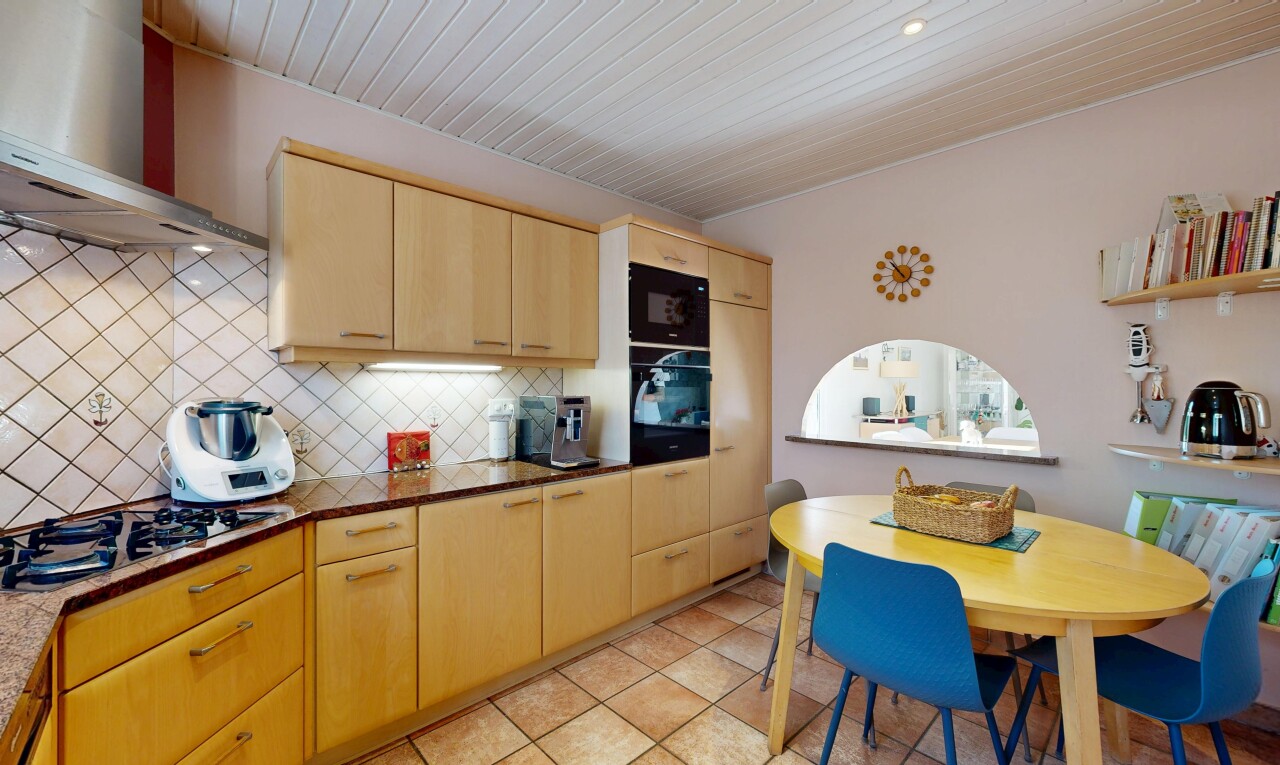 cuisine avec light brown cabinets, armoires marron clair, hotte, backsplash, et dosseret