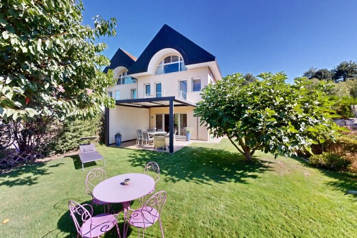 view of home with a patio, a lawn, and stucco siding