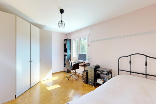 room with parquet flooring, a closet, and an office area