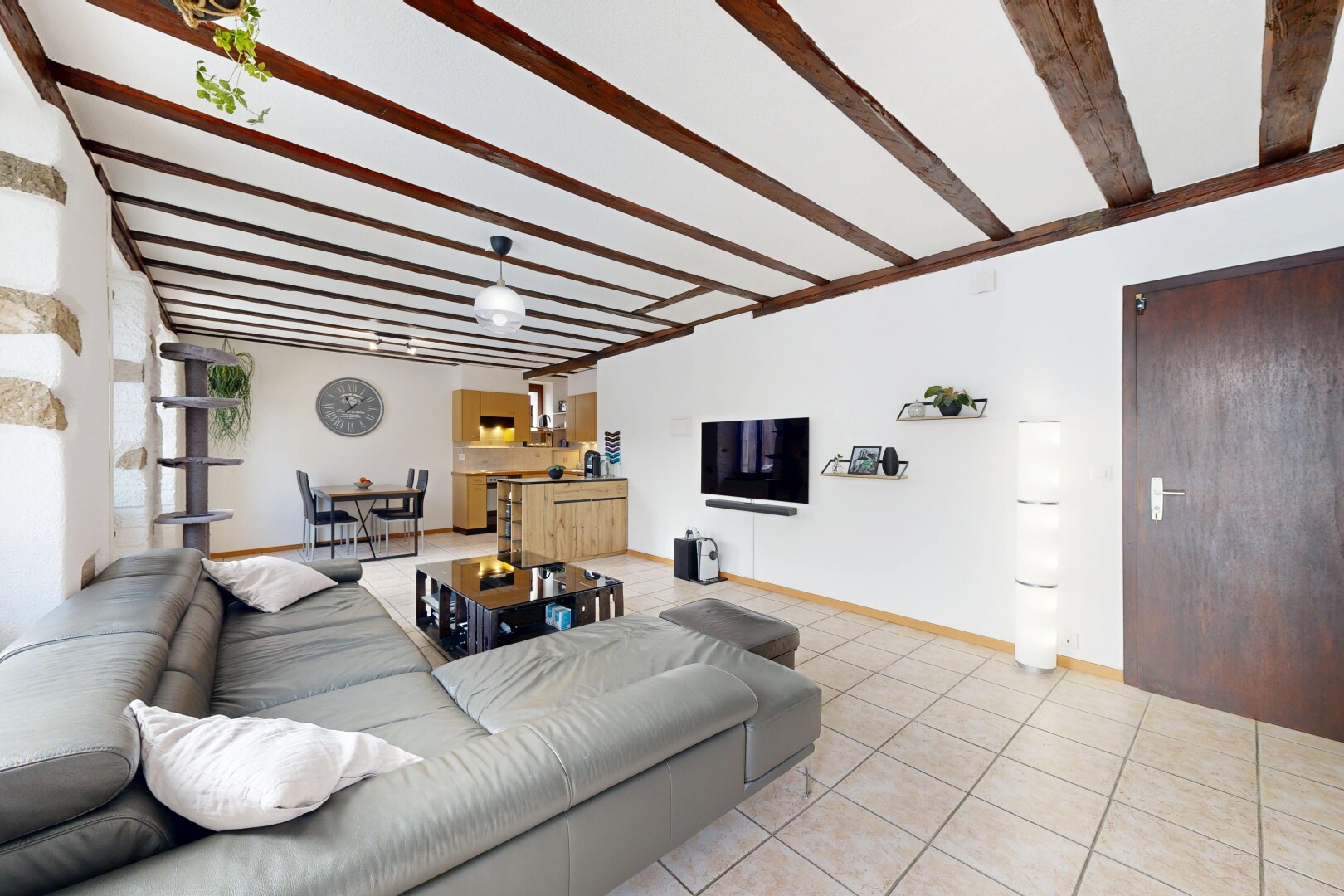 salon avec plafond à poutres, beamed ceiling, inside property, télévision, et cloison sèche