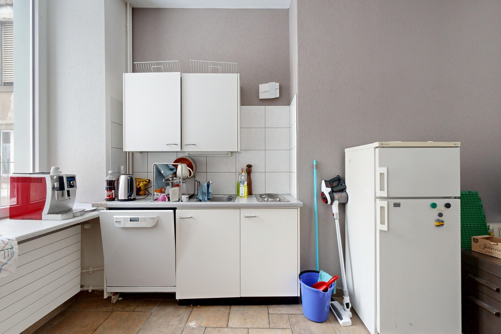 kitchen featuring light countertops, white appliances, white cabinetry, and tasteful backsplash