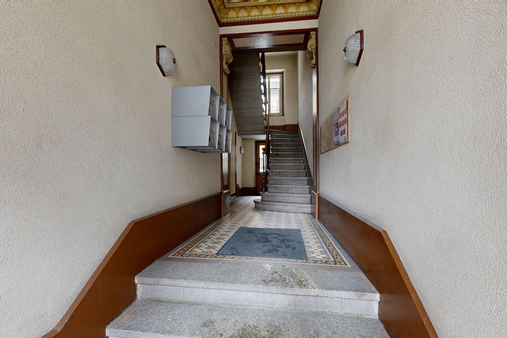 reception / lobby with a textured wall and stairway