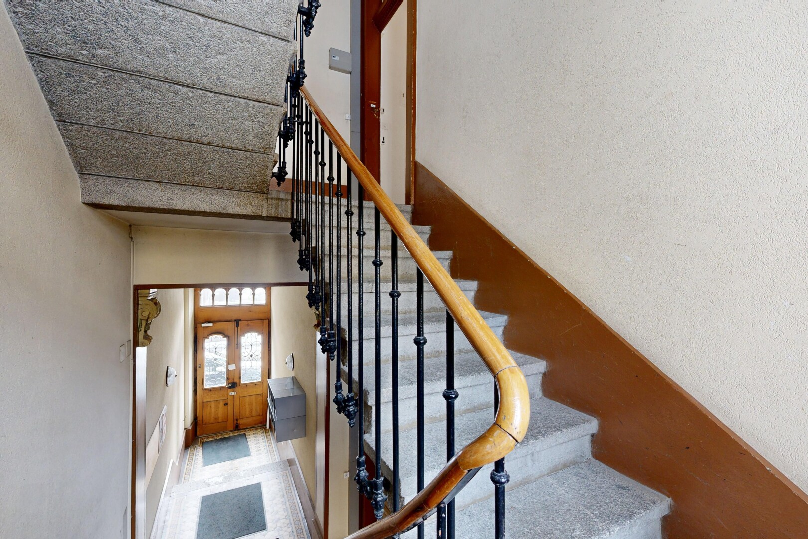 stairway with a high ceiling and baseboards