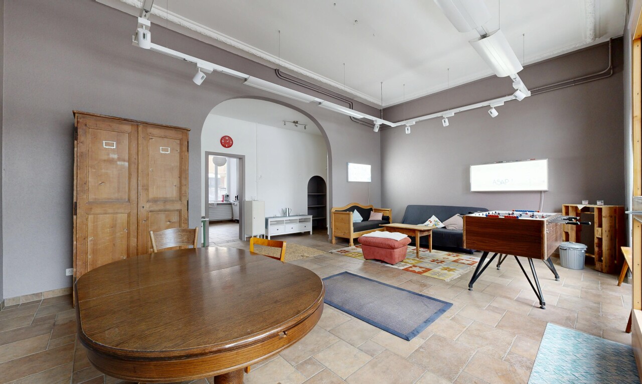 living room featuring arched walkways and rail lighting