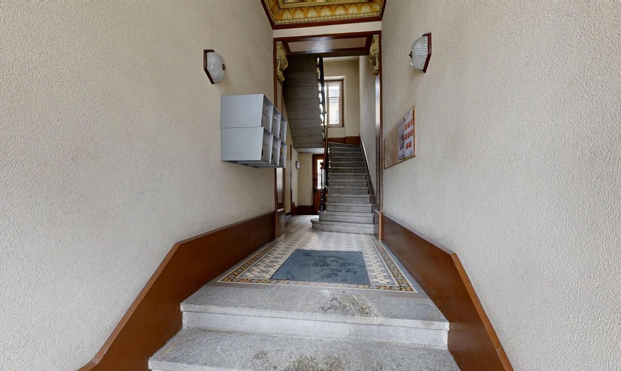 reception / lobby with a textured wall and stairway