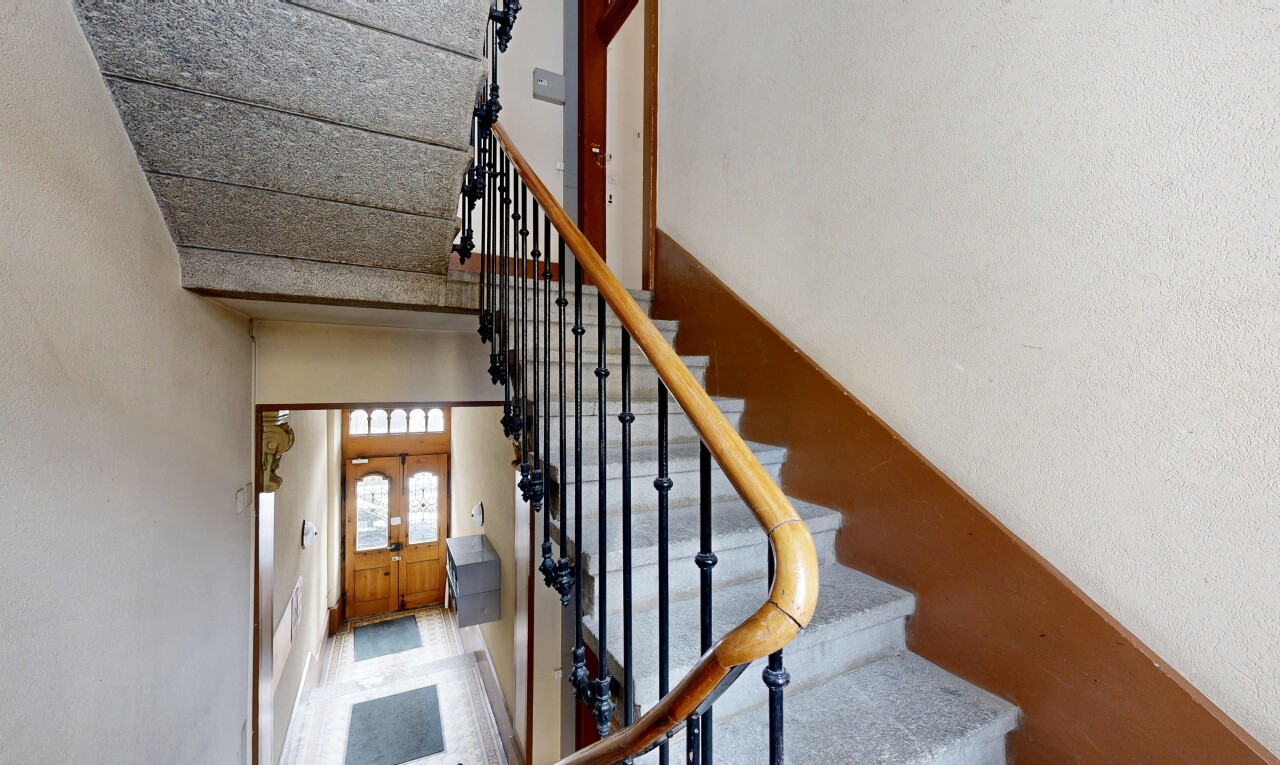 stairway with a high ceiling and baseboards
