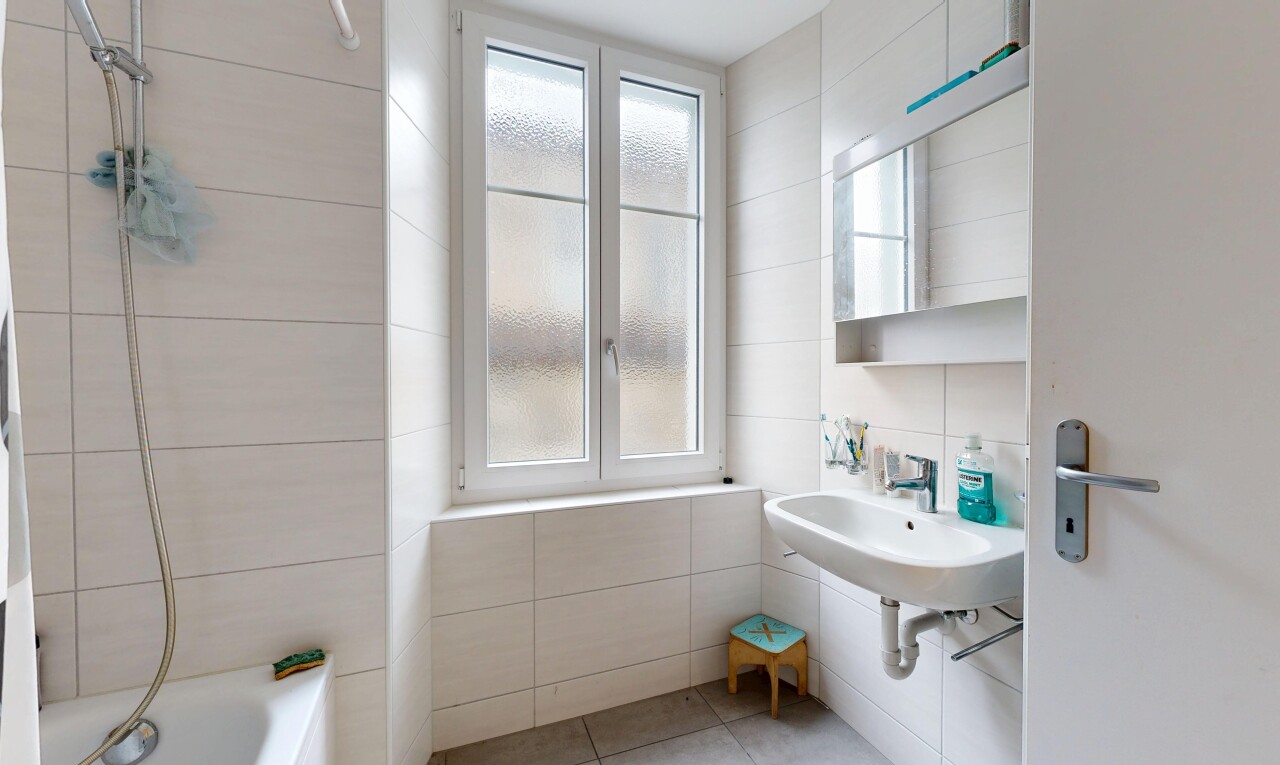 bathroom with plenty of natural light, tile walls, tile patterned floors, and shower / tub combination