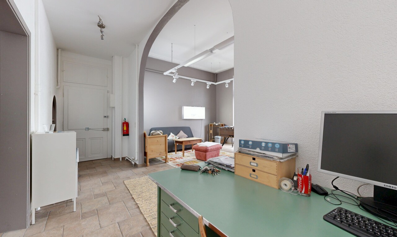 kitchen featuring arched walkways, stone finish floors, and light countertops