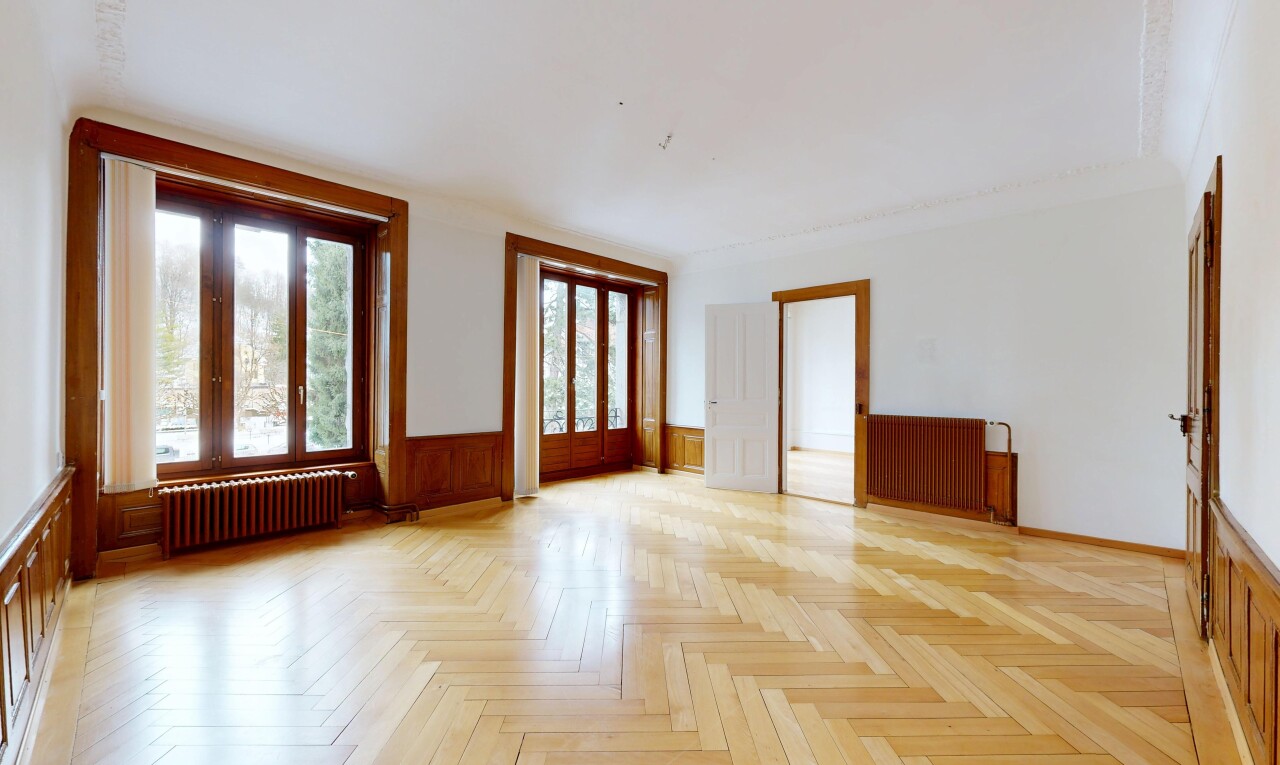 unfurnished room featuring radiator heating unit and wainscoting