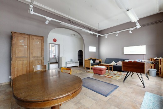 living room featuring arched walkways and rail lighting