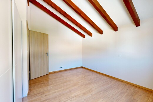 pièce vide avec beamed ceiling, plafond à poutres, vaulted ceiling, plafond voûté, et high end ceiling