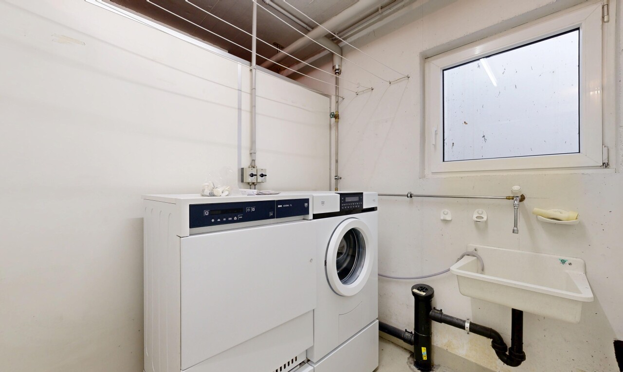 wäschekammer mit drywall, natürliches licht, inside community, waschbecken, und tumbler