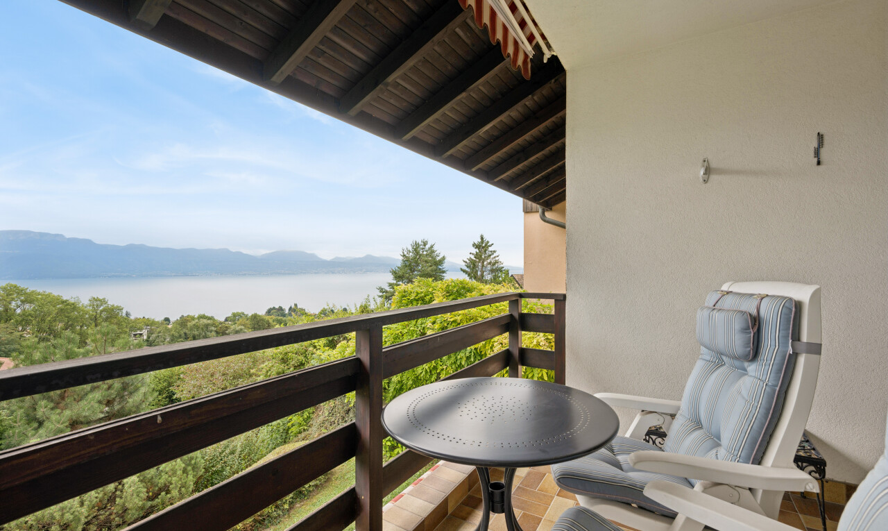 balcony featuring a water and mountain view