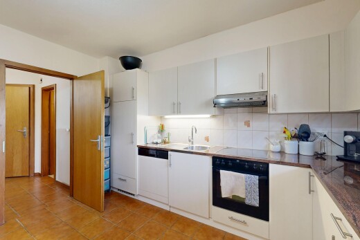 cuisine avec dosseret, backsplash, armoires blanches, four, et inside property