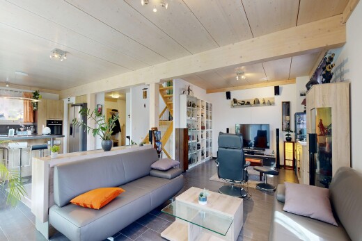 living room featuring a wooden ceiling with exposed beams and a desk