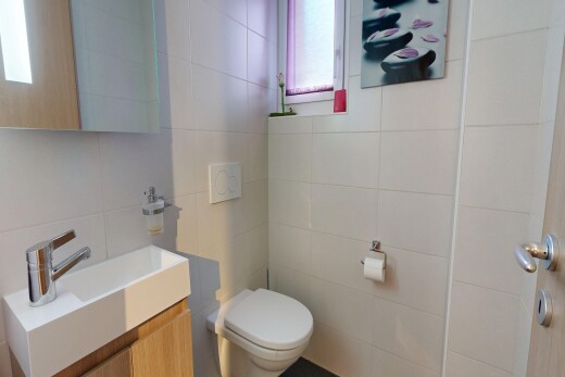 half bathroom with vanity and tile walls