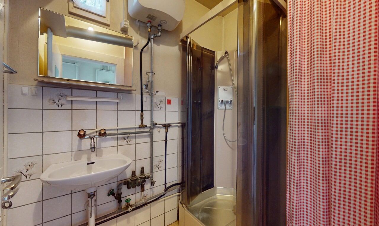 salle de bains avec inside property, miroir, chauffe-eau, dosseret, et backsplash