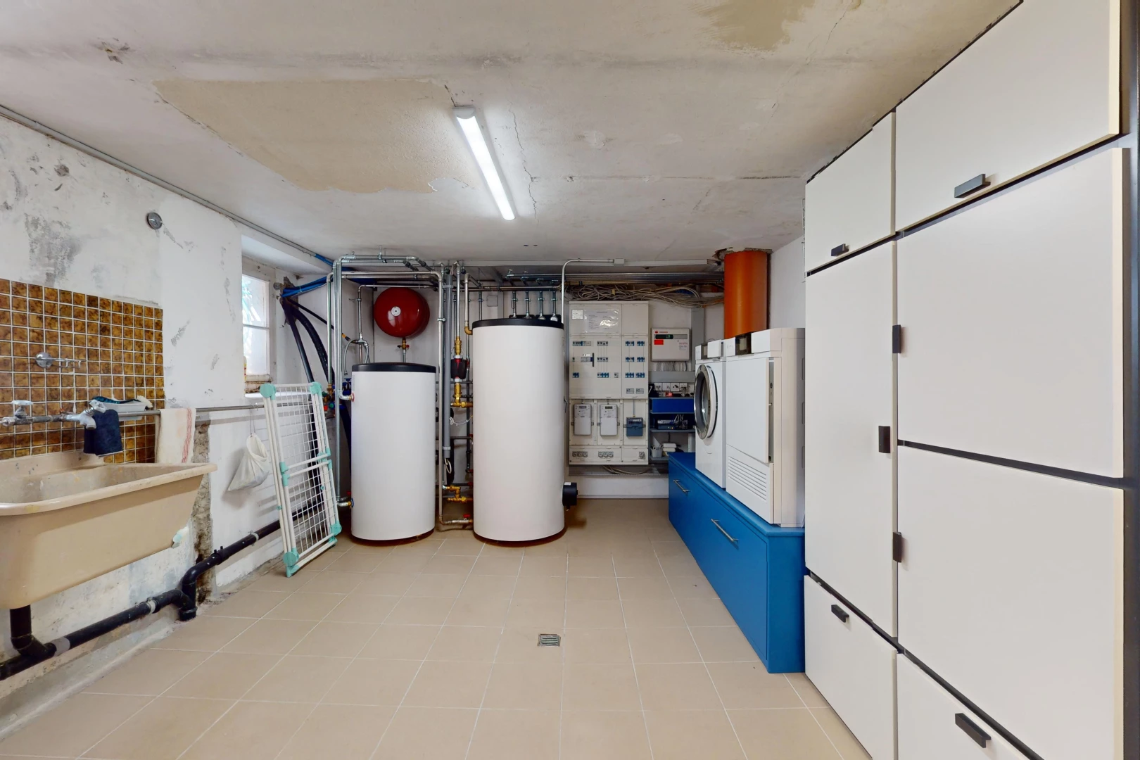 espace intérieur avec chaudière, machine à laver / sèche-linge, et carrelage