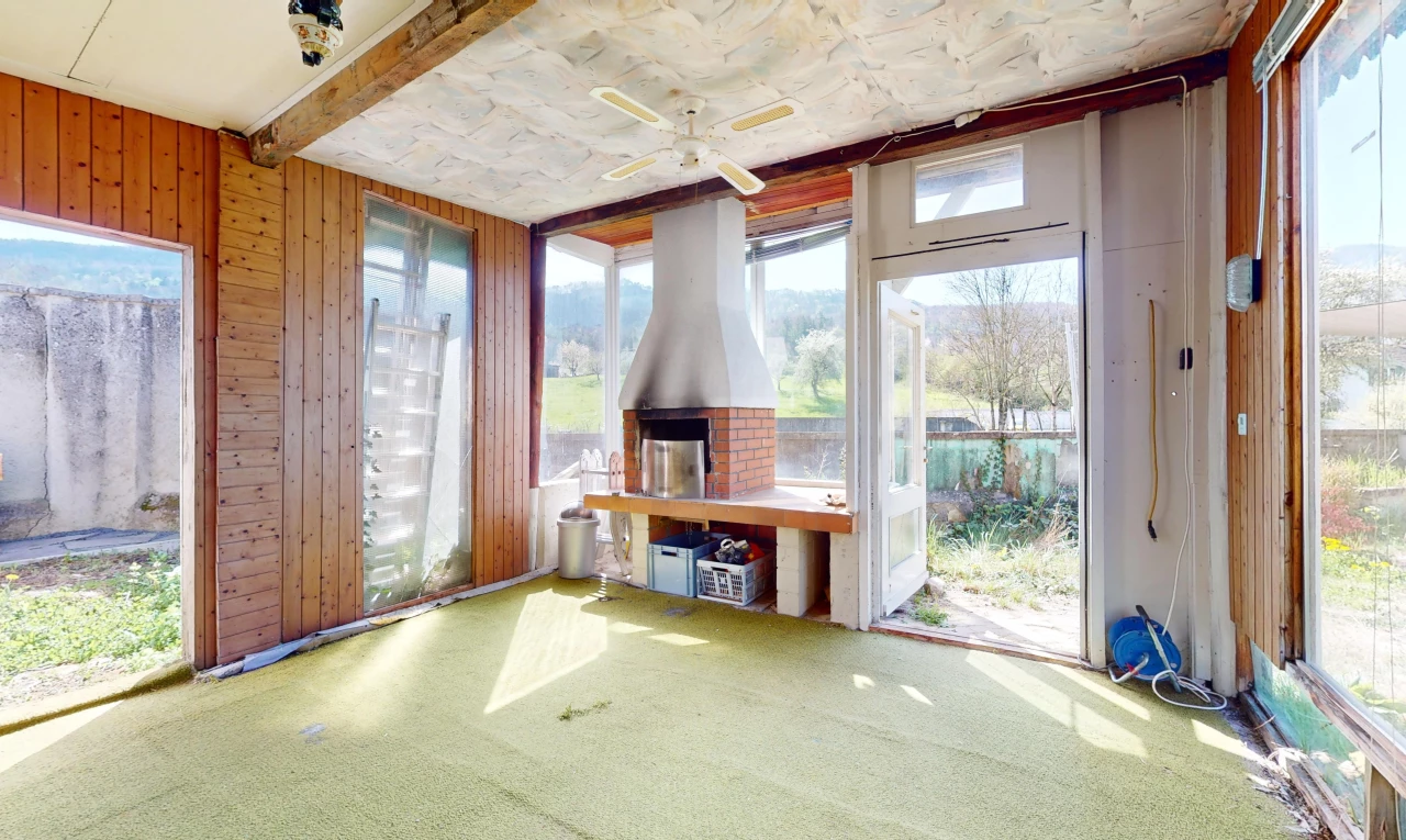 pièce vide avec mur en bois, lumière naturelle, ventilateur de plafond, et moquette