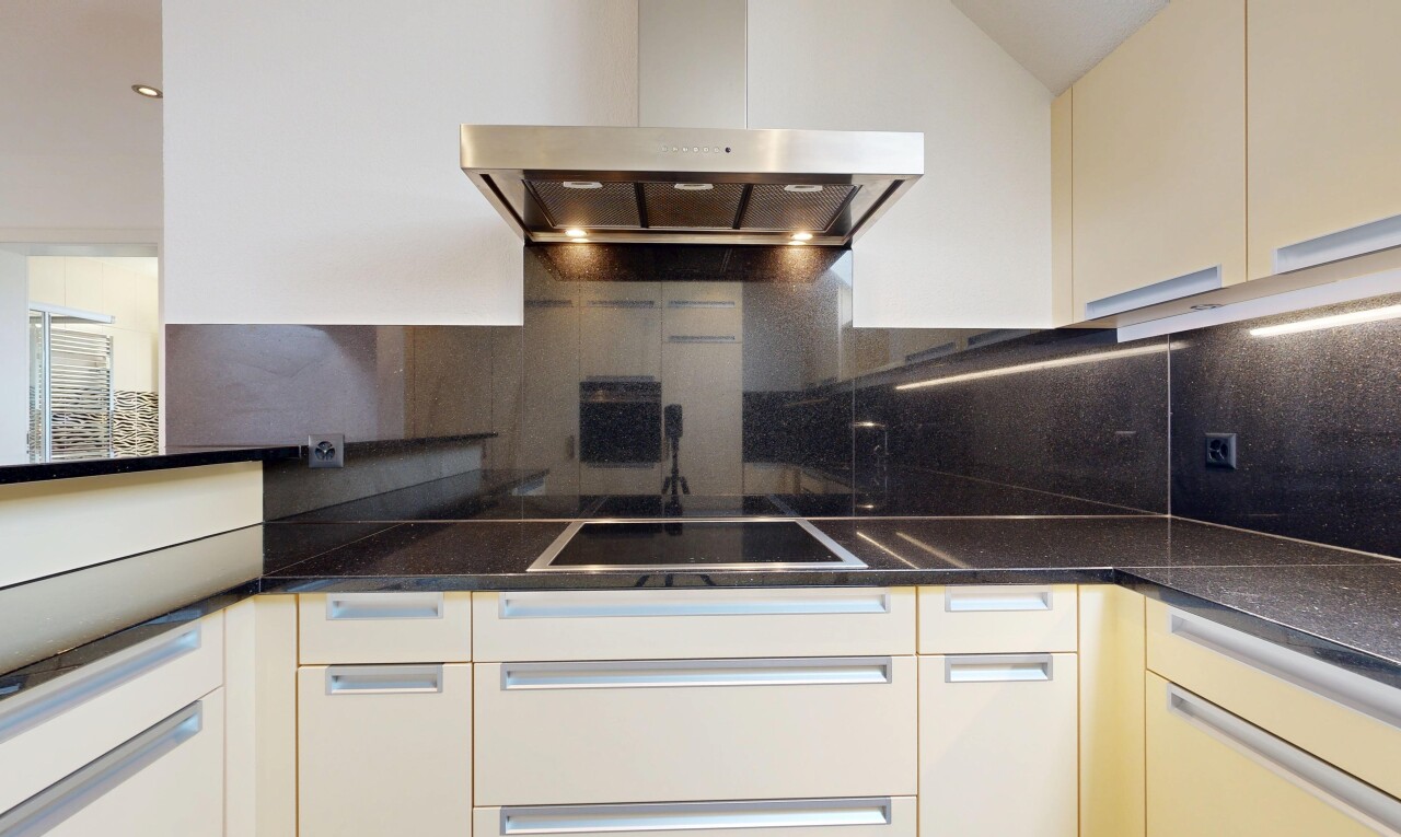 küche mit dunstabzugshaube, dark countertops, küchenrückwand beim herd, küchenrückwand beim Herd, und inside property
