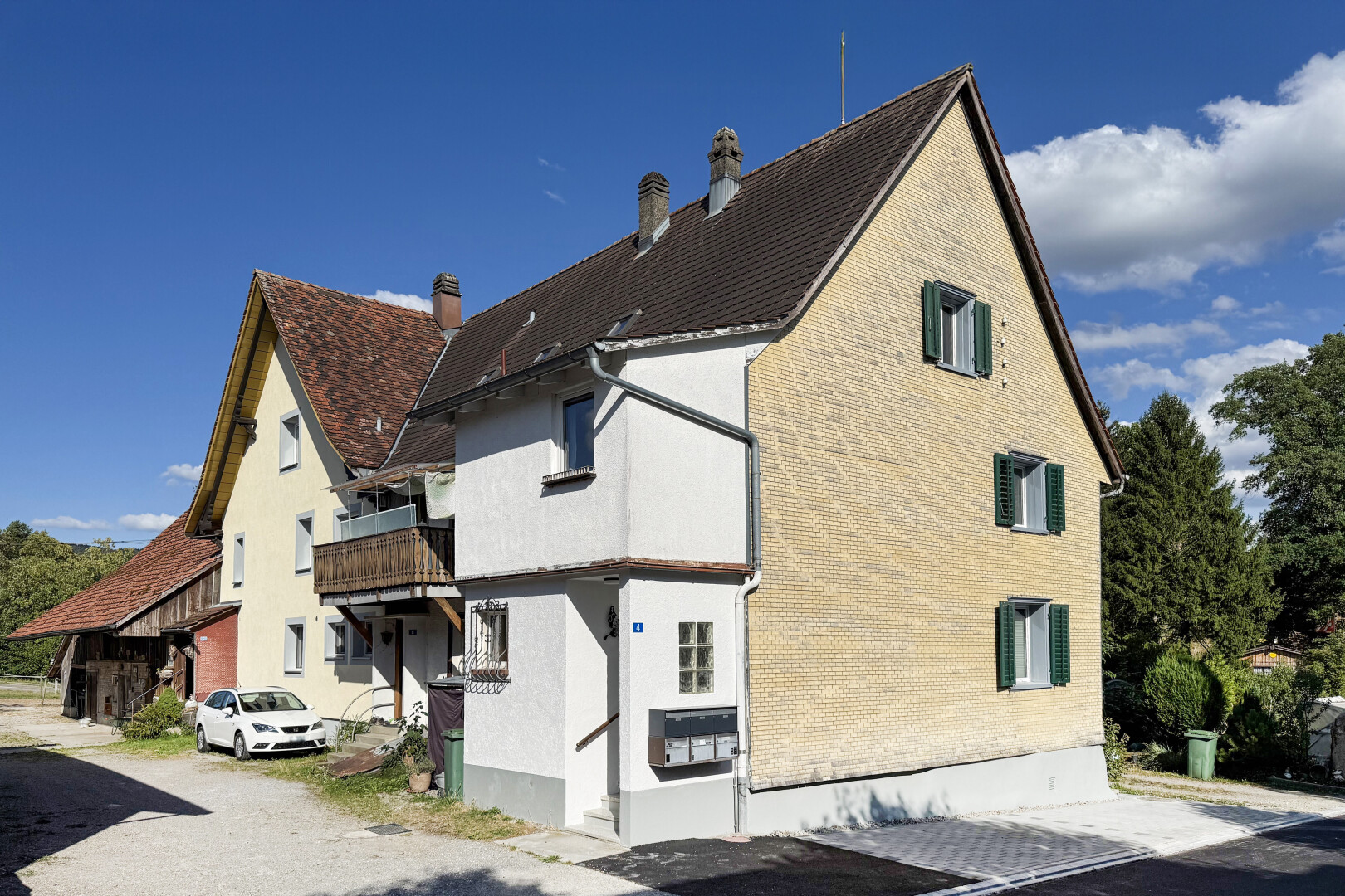 view of home featuring a chimney and a balcony
