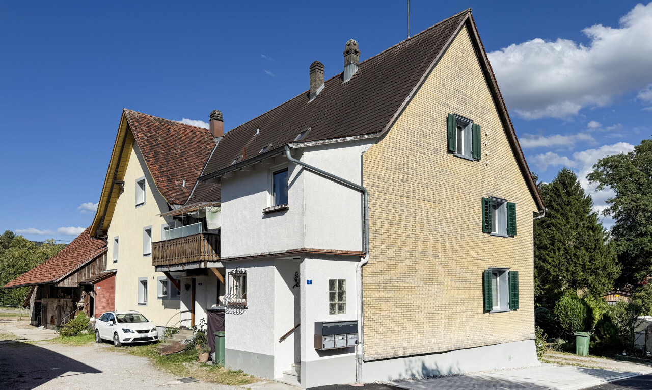 view of home featuring a chimney and a balcony