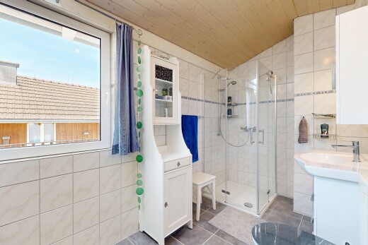 full bathroom featuring tile walls, a stall shower, a vaulted wood ceiling, vanity, and dark tile patterned floors
