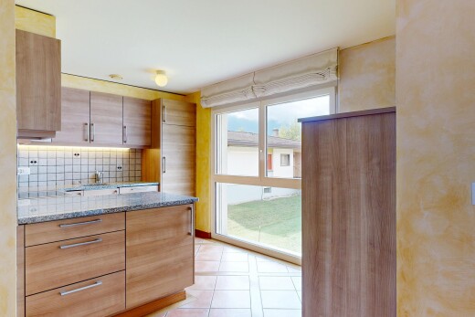 kitchen featuring light stone counters, tasteful backsplash, light tile patterned floors, modern cabinets, and brown cabinetry