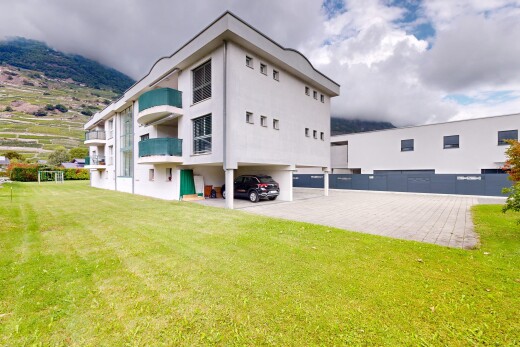 view of property featuring a lawn and stucco siding