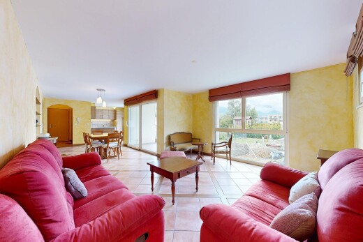 living room featuring arched walkways and light tile patterned flooring