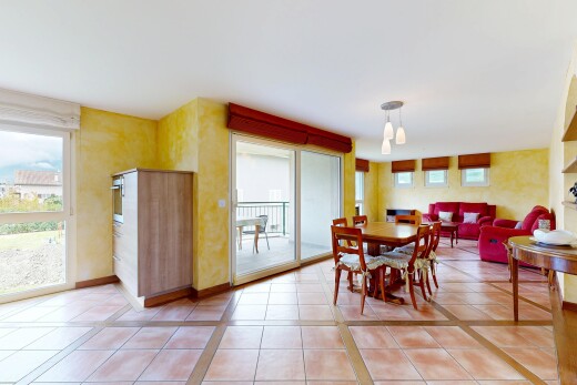 living area with light tile patterned floors and baseboards