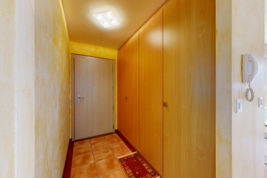 hall featuring light tile patterned floors