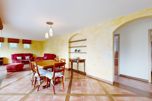 living / dining room with light tile patterned floors and inlaid floor details