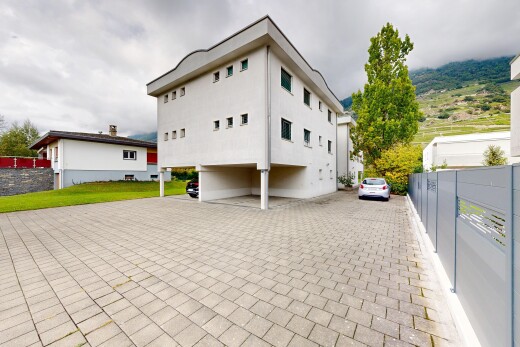view of home featuring uncovered parking