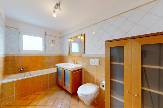 bathroom with light tile patterned flooring, vanity, a bath, and tile walls