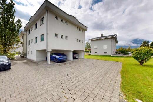 view of property with a lawn and stucco siding