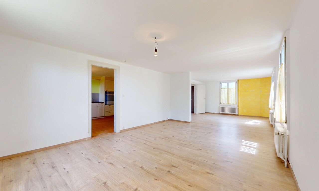 pièce vide avec radiateur, sol en finition bois, wood finish floor, inside property, et lumière naturelle