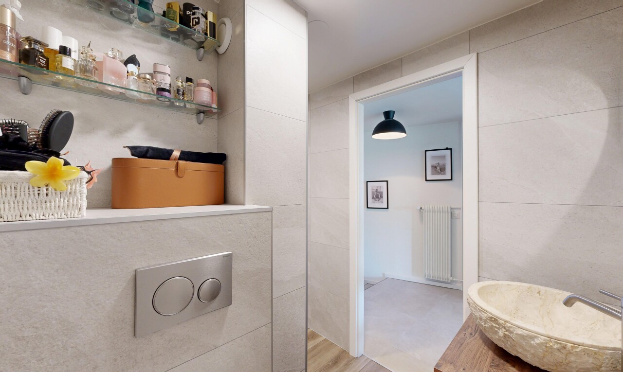 bathroom with radiator, vanity, and tile walls